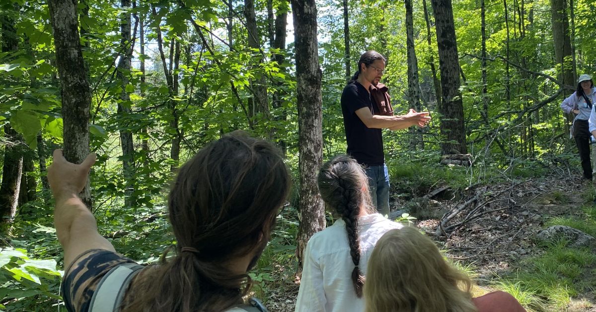 Joe Pitawanakwat leading a medicine walk through a wooded path at Tecasy Ranch